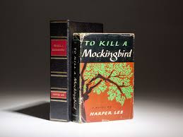 A vintage typewriter next to copies of To Kill a Mockingbird and The Diary of Anne Frank, with a soft-focus background of a bookshelf.